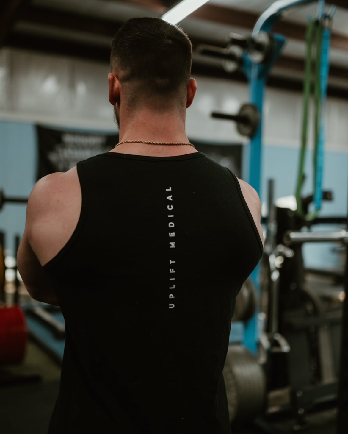 Wearing the Uplift Medical tank top at the gym